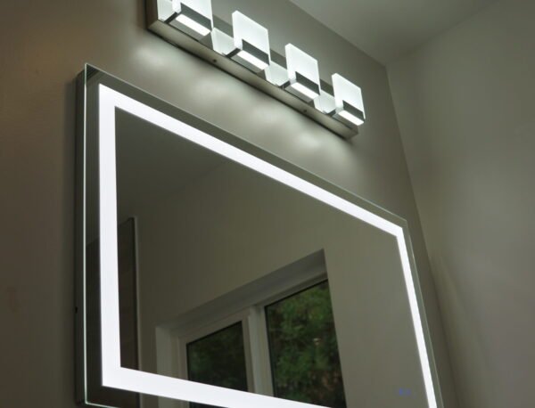 Renovated bathroom with a lighted mirror and bright vanity lights installed by LA Pro Electrical in Los Angeles, CA.