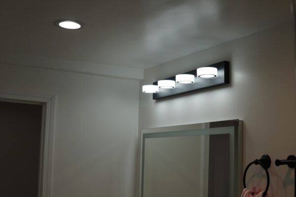 Bathroom vanity with recessed lighting and integrated mirror lighting for a seamless modern look.