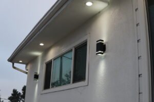 Exterior wall of a house in Los Angeles, CA, with recessed ceiling lights and modern wall sconces installed by LAProElectrical.