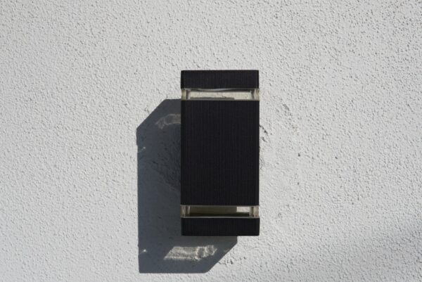 Modern black LED sconce installed outdoors for stylish lighting in Los Angeles, CA.