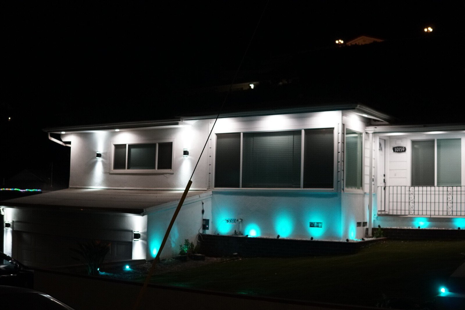 Modern home in Los Angeles illuminated at night with custom LED lighting installed by LAProElectrical, highlighting the exterior and landscape.