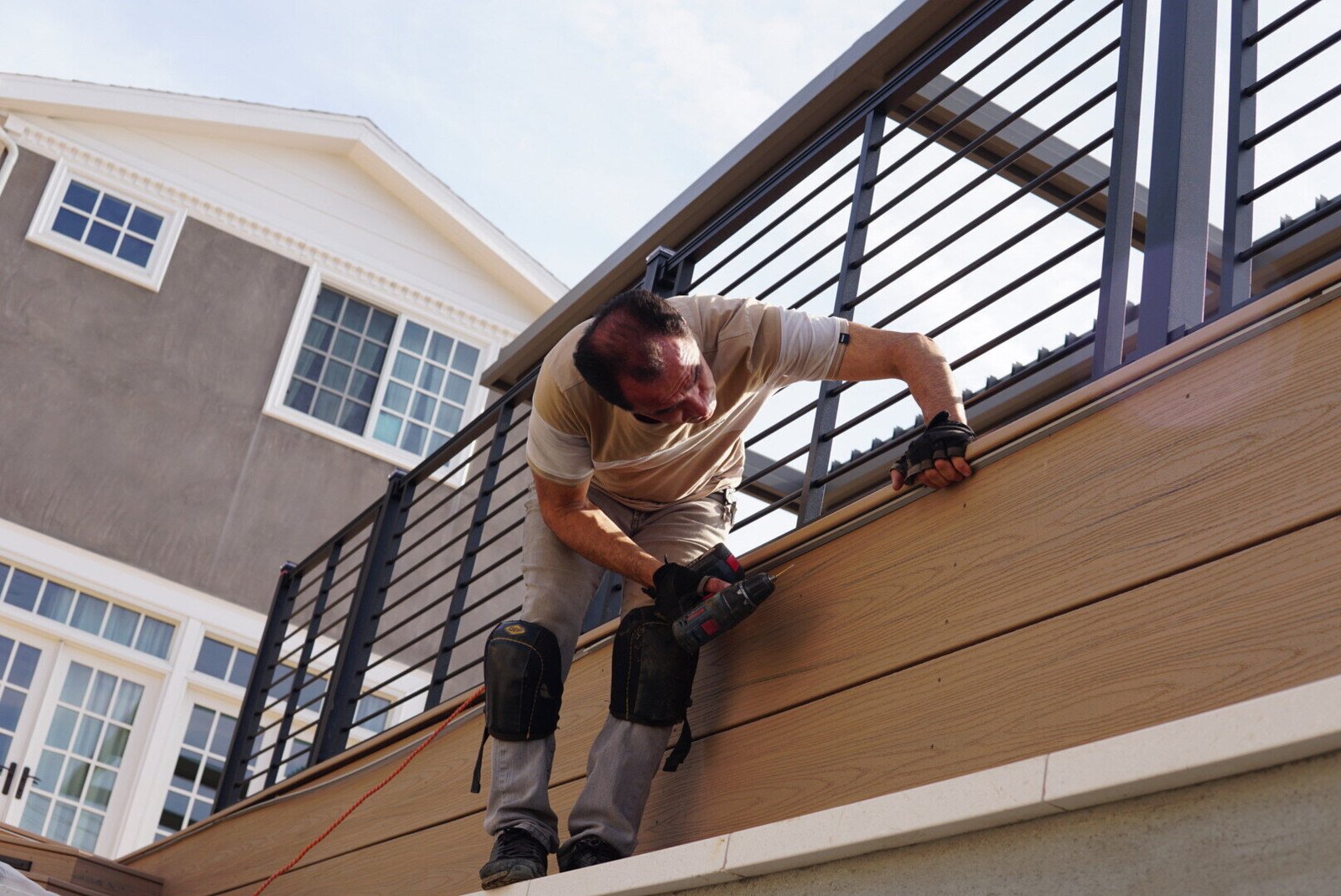 LAProElectrical worker installing patio lighting outdoors, enhancing the ambiance of a modern patio