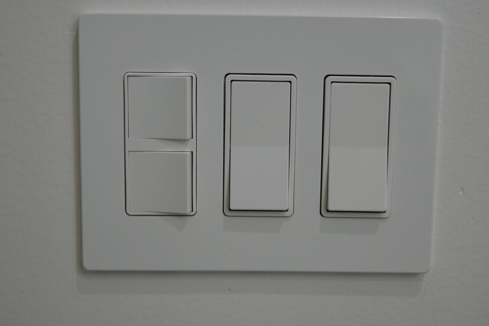 Light switches installed in a bathroom as part of a professional electrical solution.