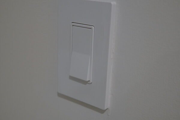 Minimalist modern light switch installed on a wall for efficient lighting control.