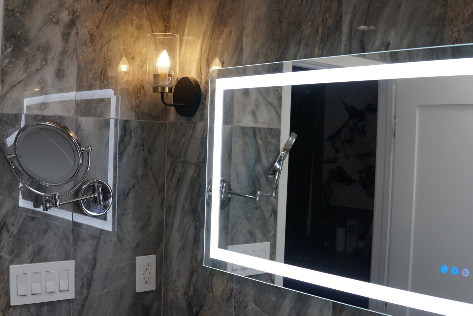 Bathroom lighting with LED mirror and wall-mounted sconce installed by LA Pro Electrical.