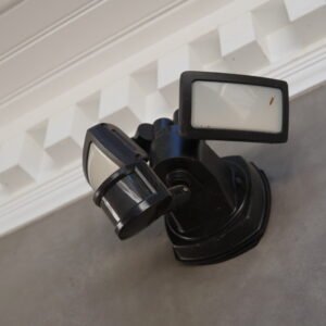 Motion-activated security light installed on an exterior wall for enhanced safety and visibility.