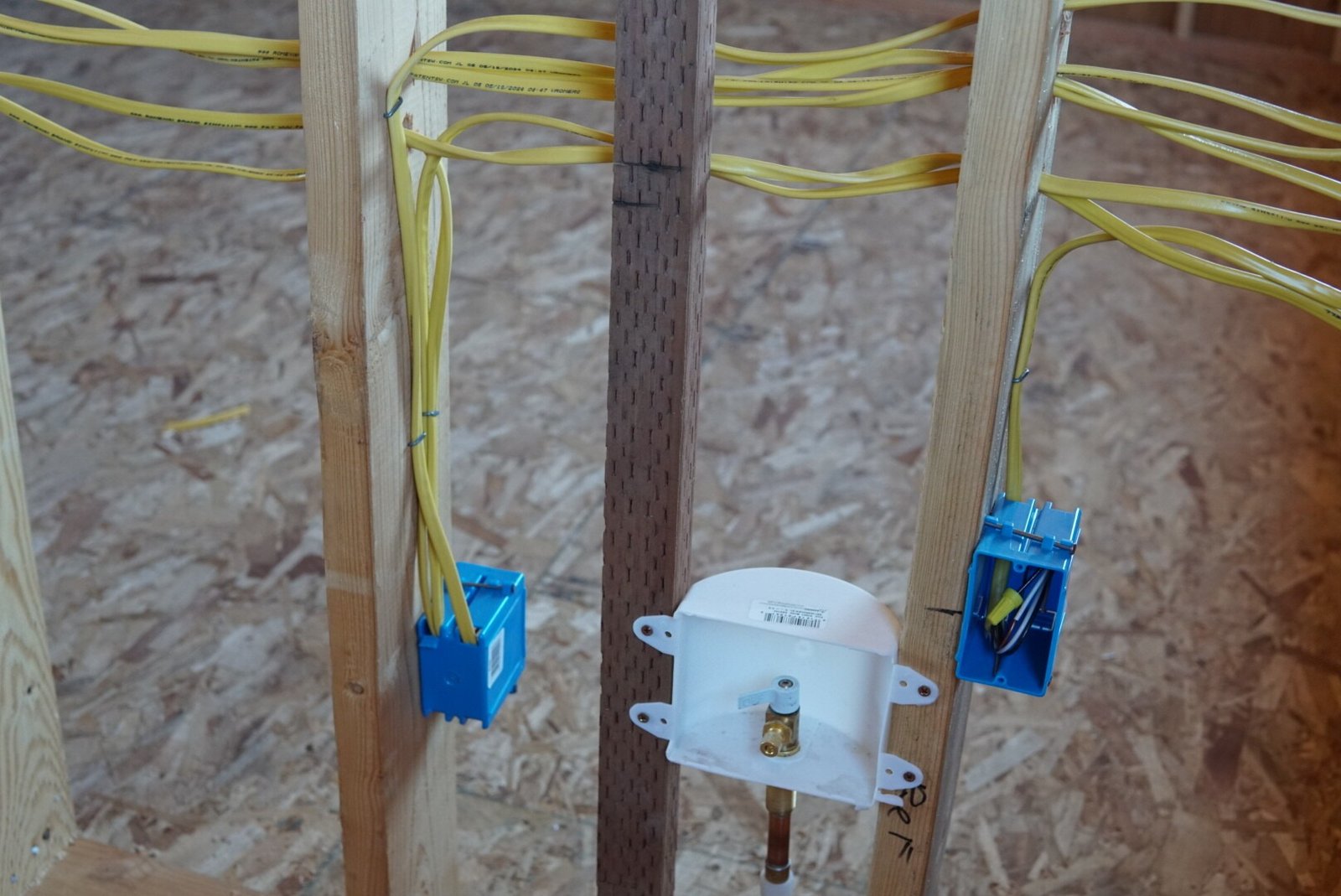 A detailed view of electrical wiring and newly installed outlets in an accessory dwelling unit (ADU) under construction.