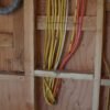 Electric install with wires being professionally run to the main panel of a residential house by LAPro Electrical.