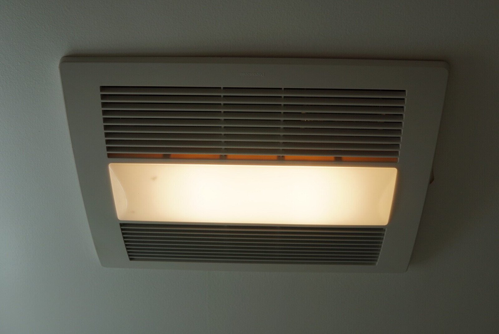 Bathroom air vent with integrated light installed for ventilation and illumination.